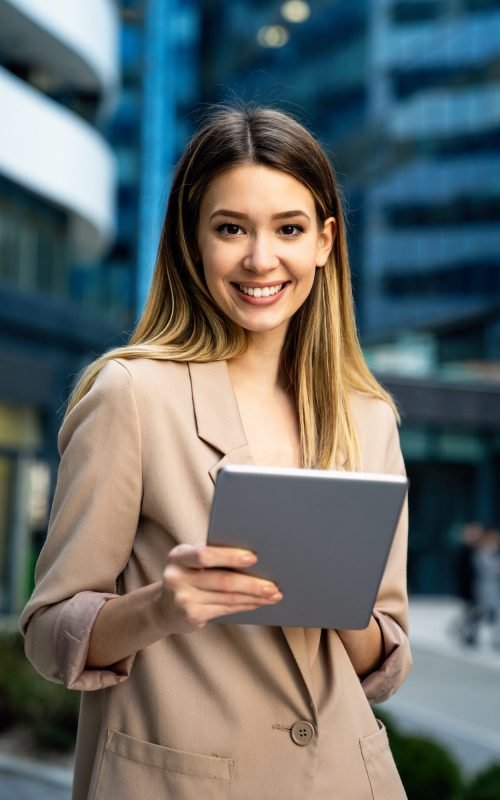 successful-businesswoman-using-a-digital-tablet-while-standing-in-front-of-business-building.jpg successful-businesswoman-using-a-digital-tablet-while-standing-in-front-of-business-building.jpg